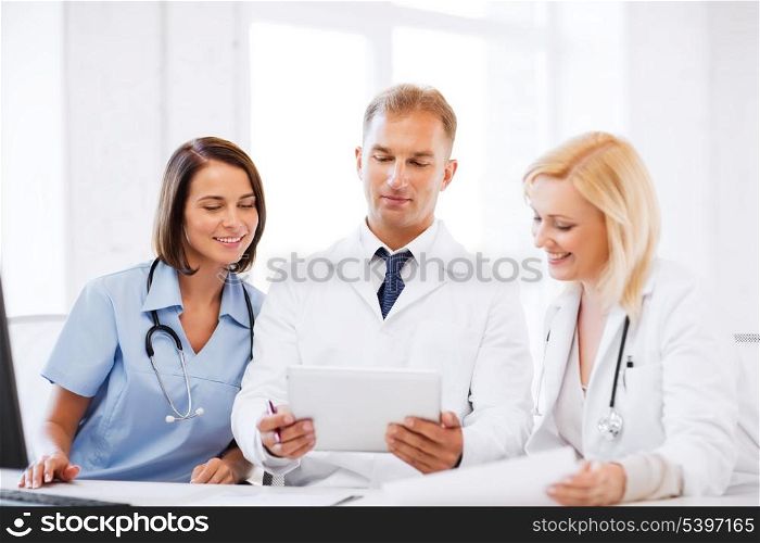 healthcare, medical and technology concept - doctors looking at tablet pc