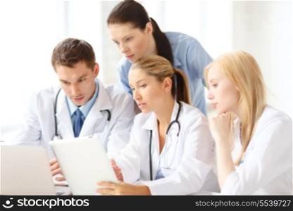 healthcare, medical and technology concept - ggroup of doctors with laptop and tablet pc computer in hospital