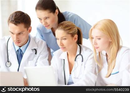 healthcare, medical and technology concept - ggroup of doctors with laptop and tablet pc computer in hospital