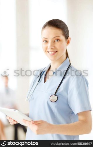 healthcare, medical and technology concept - smiling female doctor or nurse with tablet pc in hospital with team on background