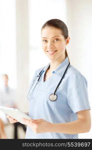 healthcare, medical and technology concept - smiling female doctor or nurse with tablet pc in hospital with team on background