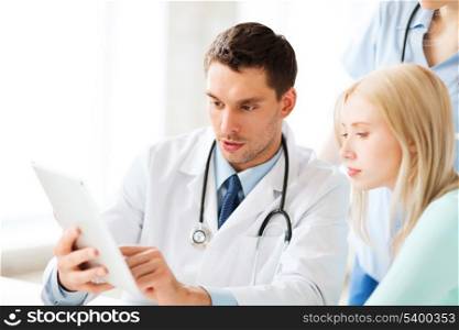 healthcare, medical and technology - doctor showing something patient on tablet pc in hospital