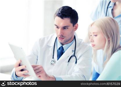 healthcare, medical and technology - doctor showing something patient on tablet pc in hospital