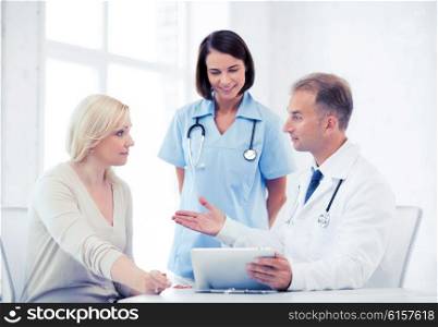 healthcare, medical and technology - doctor showing something to patient on tablet pc