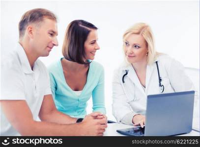 healthcare, medical and technology - doctor with patients looking at laptop