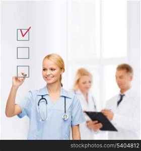 healthcare, medical and technology - smiling doctor or nurse drawing red checmark into checkbox