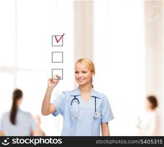 healthcare, medical and technology - smiling doctor or nurse drawing red checmark into checkbox