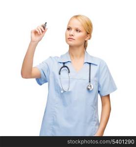 healthcare, medical and technology - young doctor or nurse writing something in the air