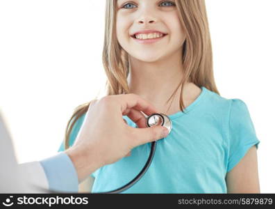 healthcare, medical exam, people, children and medicine concept - close up of happy girl and doctor hand with stethoscope listening to heartbeat