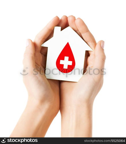 healthcare, medicine and blood donation concept - hands holding hands holding white paper house with red donor sign