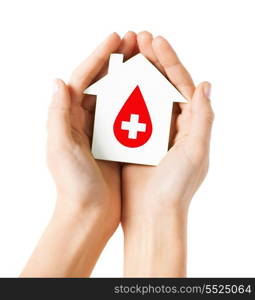 healthcare, medicine and blood donation concept - hands holding hands holding white paper house with red donor sign