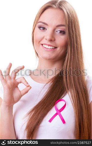 Healthcare, medicine and breast cancer awareness concept. Content young woman with pink cancer ribbon on chest making ok hand sign gesture, isolated on white. woman pink cancer ribbon on chest making ok sign