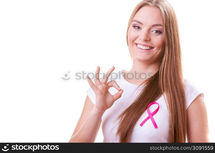 Healthcare, medicine and breast cancer awareness concept. Content young woman with pink cancer ribbon on chest making ok hand sign gesture, isolated on white. woman pink cancer ribbon on chest making ok sign
