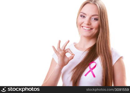 Healthcare, medicine and breast cancer awareness concept. Content young woman with pink cancer ribbon on chest making ok hand sign gesture, isolated on white. woman pink cancer ribbon on chest making ok sign