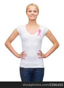 healthcare, medicine and breast cancer concept - woman in blank t-shirt with pink cancer ribbon