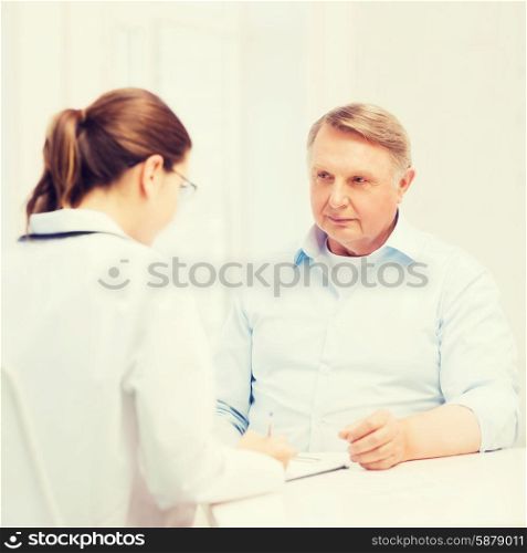 healthcare, medicine and elderly concept - female doctor or nurse with old man prescribing