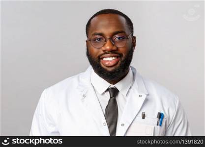 Healthcare, medicine and hospital treatment concept. Close-up portrait of smiling handsome african-american doctor, physician in glasses and white coat, have online videocall appointment with patient.. Healthcare, medicine and hospital treatment concept. Close-up portrait of smiling handsome african-american doctor, physician in glasses and white coat, have online videocall appointment with patient