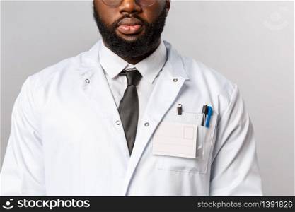 Healthcare, medicine and hospital treatment concept. Cropped shot of bearded african-american doctor in white coat and tie, wear uniform for his night shit at clinic treating patients.. Healthcare, medicine and hospital treatment concept. Cropped shot of bearded african-american doctor in white coat and tie, wear uniform for his night shit at clinic treating patients