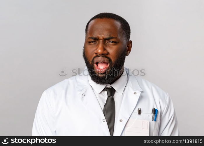 Healthcare, medicine and hospital treatment concept. What the hell are you talking about. Frustrated and displeased african-american doctor, therapist cringe, grimacing with disbelief at camera.. Healthcare, medicine and hospital treatment concept. What the hell are you talking about. Frustrated and displeased african-american doctor, therapist cringe, grimacing with disbelief at camera