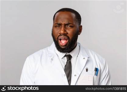 Healthcare, medicine and hospital treatment concept. What the hell are you talking about. Frustrated and displeased african-american doctor, therapist cringe, grimacing with disbelief at camera.. Healthcare, medicine and hospital treatment concept. What the hell are you talking about. Frustrated and displeased african-american doctor, therapist cringe, grimacing with disbelief at camera