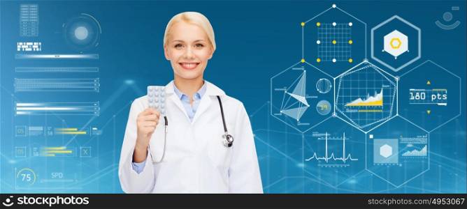 healthcare, medicine and medication concept - smiling female doctor with pills and stethoscope over blue background and charts. smiling female doctor with pills