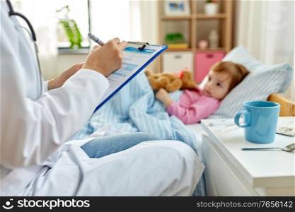 healthcare, medicine and people concept - close up of doctor with clipboard and little sick girl lying in bed at home. doctor with clipboard and sick girl in bed at home