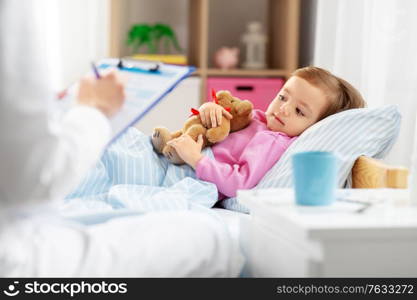 healthcare, medicine and people concept - doctor with clipboard and little sick girl lying in bed at home. doctor with clipboard and sick girl in bed at home