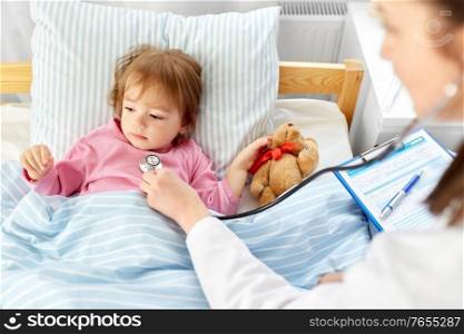 healthcare, medicine and people concept - doctor with stethoscope checking little sick girl&rsquo;s lungs at home. doctor with stethoscope and sick girl in bed