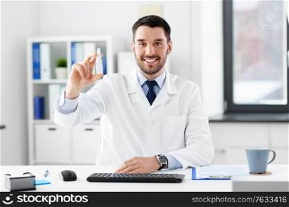healthcare, medicine and people concept - happy smiling male doctor with nasal spray at hospital. smiling male doctor with medicine at hospital