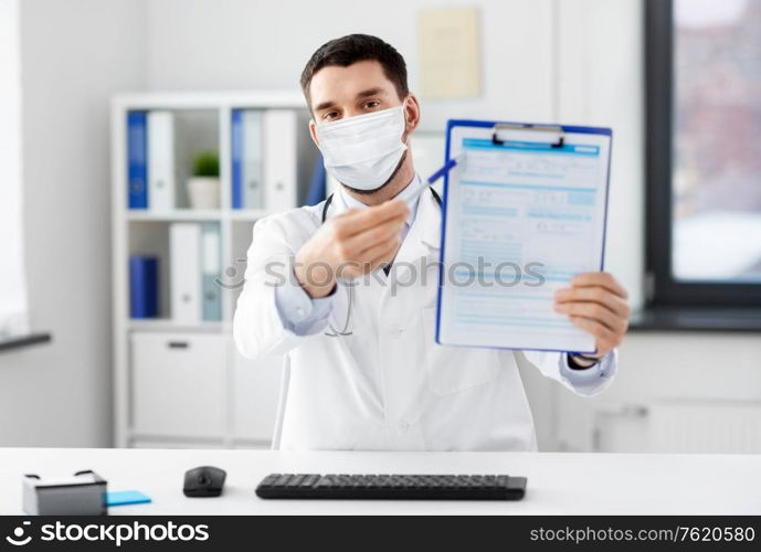 healthcare, medicine and people concept - male doctor with clipboard having video conference at hospital. doctor with clipboard having video call at clinic