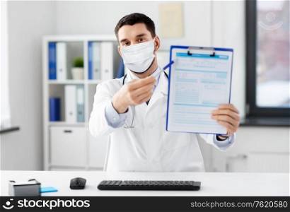 healthcare, medicine and people concept - male doctor with clipboard having video conference at hospital. doctor with clipboard having video call at clinic