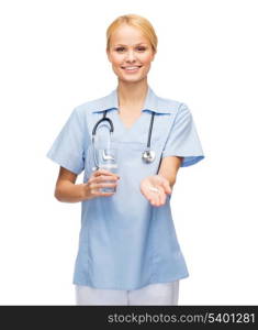 healthcare, medicine and pharmacy concept - smiling doctor or nurse with stethoscope offering pills and glass of water