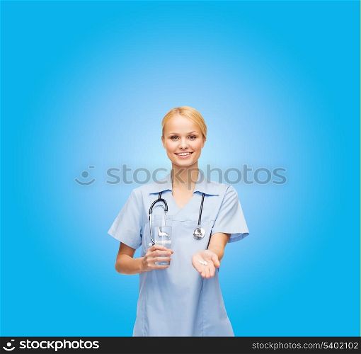 healthcare, medicine and pharmacy concept - smiling doctor or nurse with stethoscope offering pills and glass of water