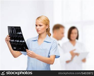 healthcare, medicine and radiology concept - smiling doctor or nurse looking at x-ray