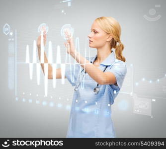 healthcare, medicine and technology concept - serious young doctor or nurse working with cardiogram on virtual screen