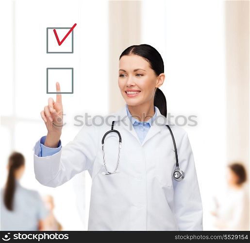 healthcare, medicine and technology concept - smiling female doctor pointing to checkbox
