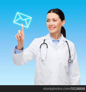 healthcare, medicine and technology concept - smiling female doctor pointing to envelope