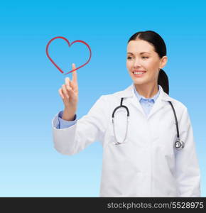 healthcare, medicine and technology concept - smiling female doctor pointing to heart