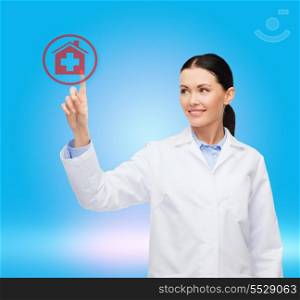 healthcare, medicine and technology concept - smiling female doctor pointing to hospital sign