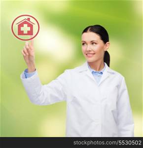 healthcare, medicine and technology concept - smiling female doctor pointing to hospital sign