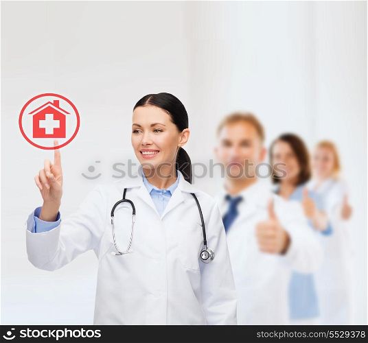 healthcare, medicine and technology concept - smiling female doctor pointing to something or pressing imaginary button