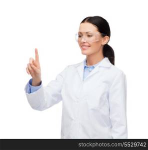 healthcare, medicine and technology concept - smiling female doctor with goggles pointing to something or pressing imaginary button
