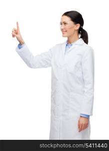 healthcare, medicine and technology concept - smiling female doctor without stethoscope pointing to something or pressing imaginary button