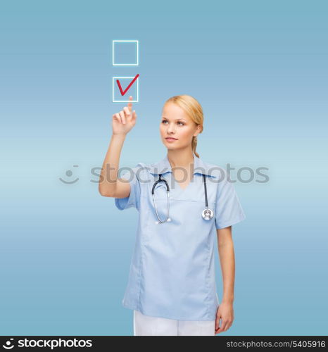 healthcare, medicine and technology concept - smiling young doctor or nurse drawing red checkmark into checkbox