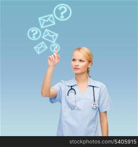 healthcare, medicine and technology concept - smiling young doctor or nurse pointing to something or pressing imaginary button