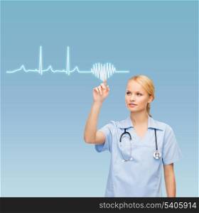 healthcare, medicine and technology concept - smiling young doctor or nurse pointing to cardiogram