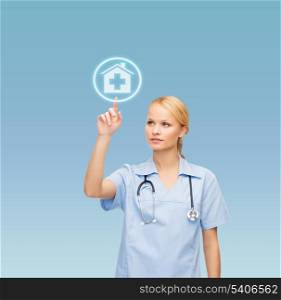 healthcare, medicine and technology concept - smiling young doctor or nurse pointing to hospital icon