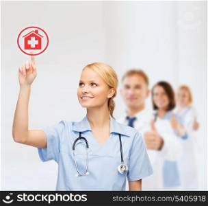 healthcare, medicine and technology concept - smiling young doctor or nurse pointing to red hospital icon