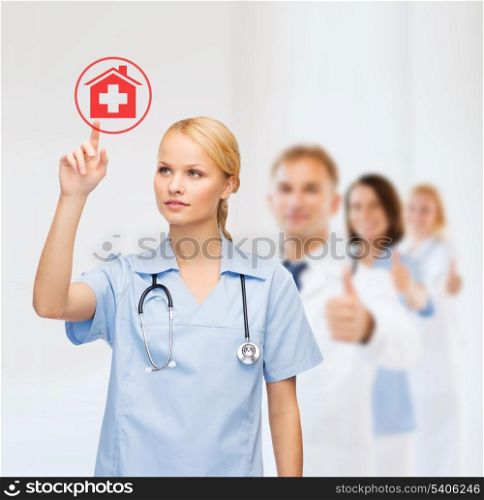 healthcare, medicine and technology concept - smiling young doctor or nurse pointing to red hospital icon