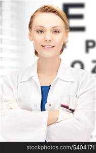 healthcare, medicine and vision concept - female ophthalmologist with eye chart